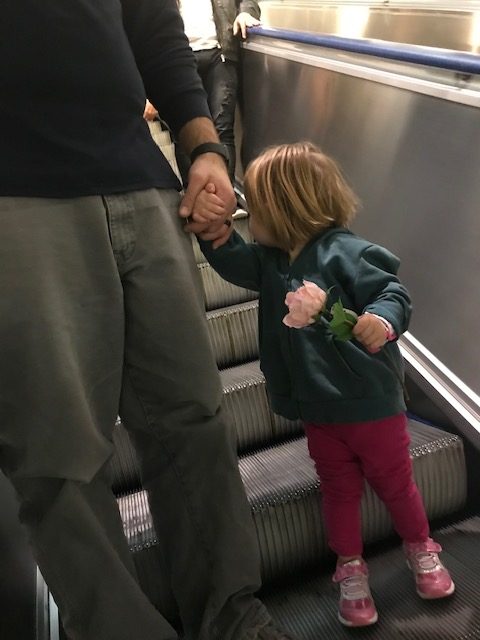 Margaret holding her dad's hand on the IKEA escalator